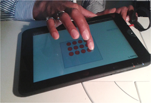 A person using a haptics enabled tablet.