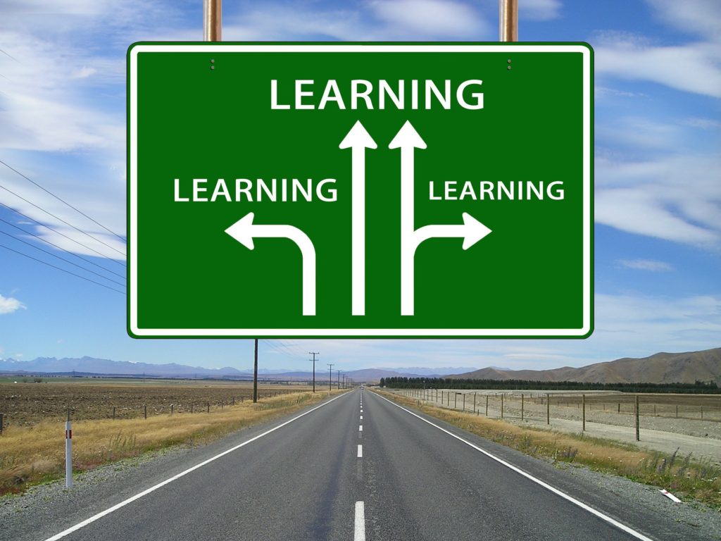 On a road with a sign "Learning" pointing in a variety of directions.