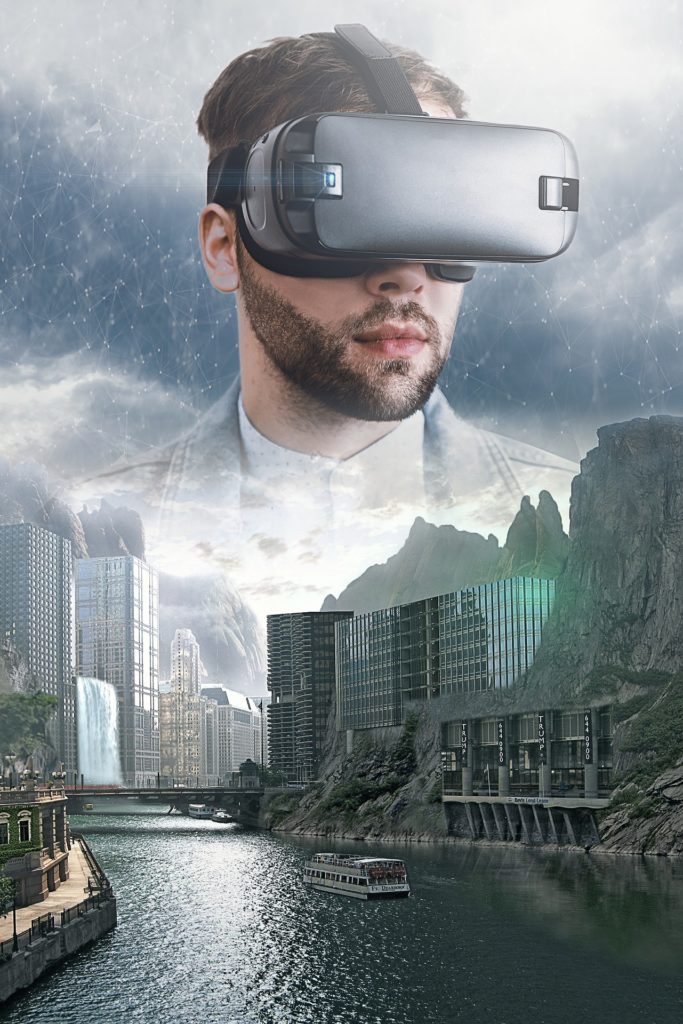 Young man wearing a VR headset, showing a futuristic city with a buildings built into the side of a mountain.